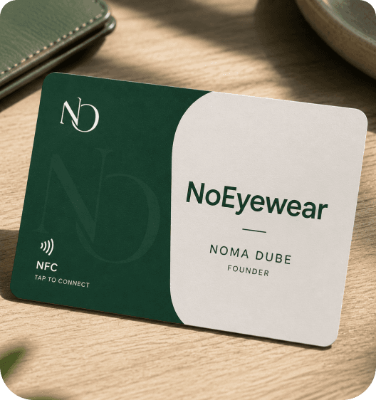 A MyKànsi NFC business card resting on a wooden desk